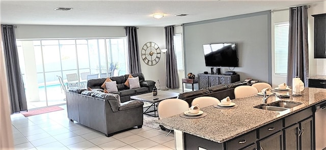 living room with sink and light tile patterned flooring