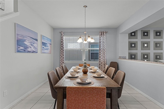 dining area featuring a chandelier and light tile patterned flooring