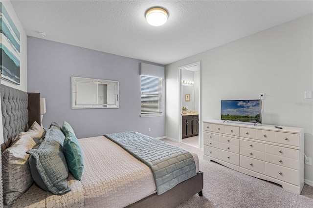 carpeted bedroom featuring connected bathroom and a textured ceiling