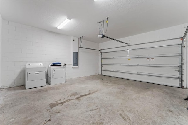 garage with washer and dryer, electric panel, and a garage door opener