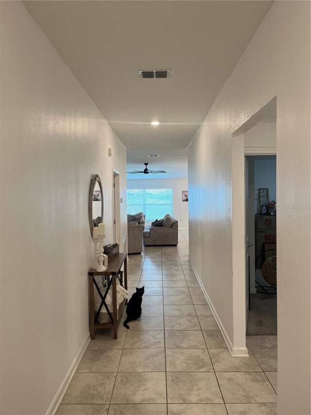 hall featuring light tile floors