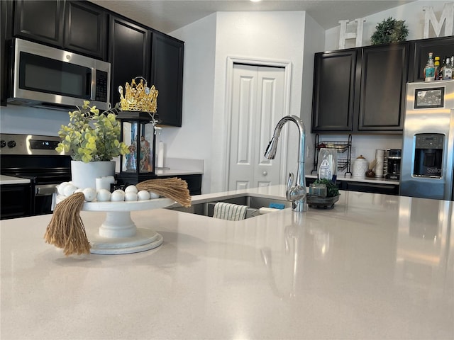 kitchen with sink and appliances with stainless steel finishes