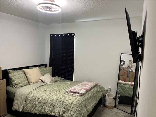 carpeted bedroom featuring a textured ceiling