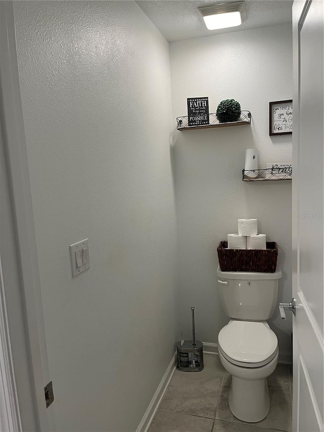 bathroom with tile flooring and toilet