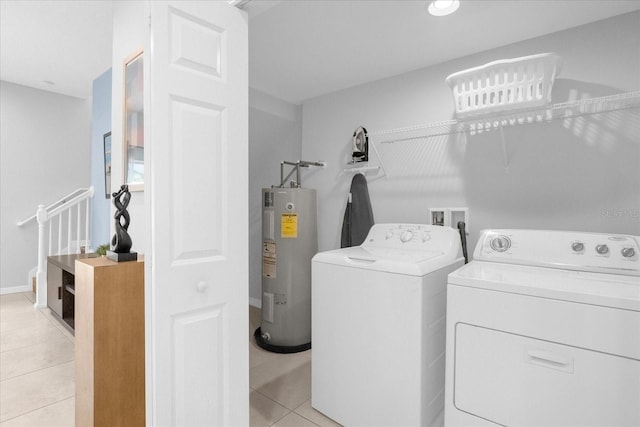 washroom with water heater, light tile patterned floors, and independent washer and dryer