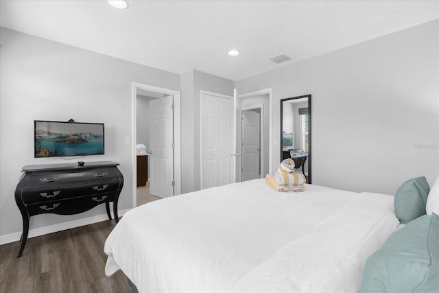 bedroom with dark wood-type flooring