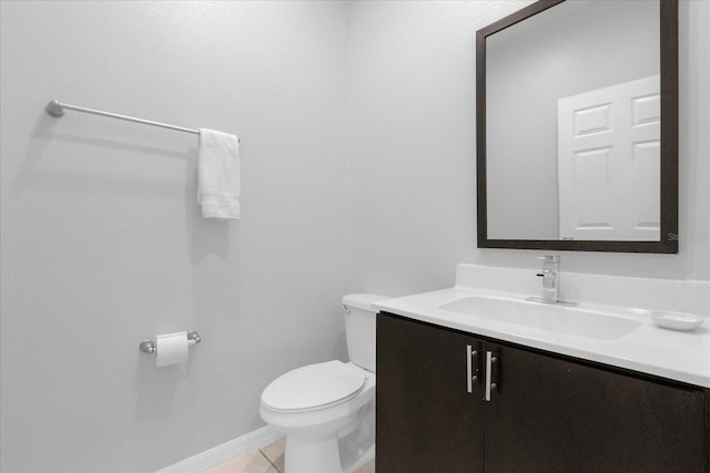 bathroom with tile patterned flooring, vanity, and toilet