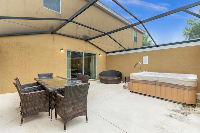 view of patio / terrace featuring a lanai and a hot tub