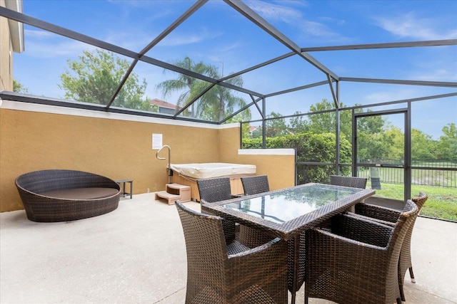 view of patio featuring a lanai and a hot tub