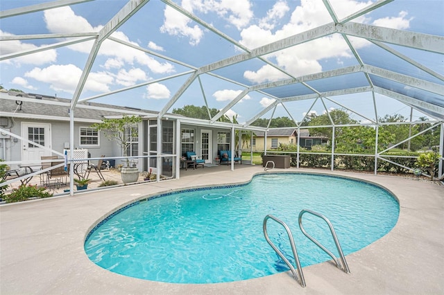 view of swimming pool with glass enclosure and a patio