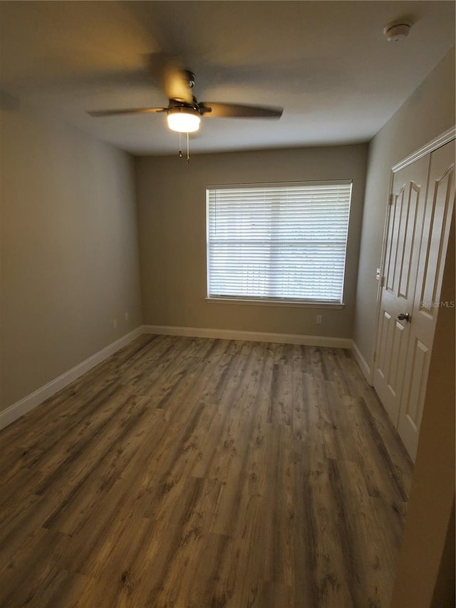 spare room with ceiling fan and dark hardwood / wood-style flooring