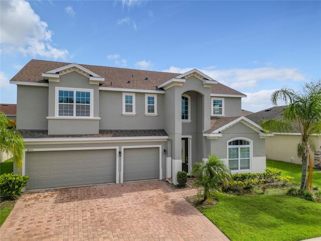 view of front of home featuring a garage and a front yard