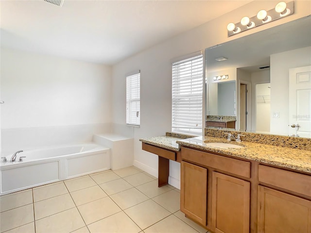 bathroom featuring tile flooring, a washtub, and vanity