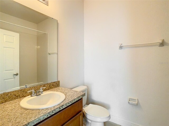 bathroom featuring toilet and vanity