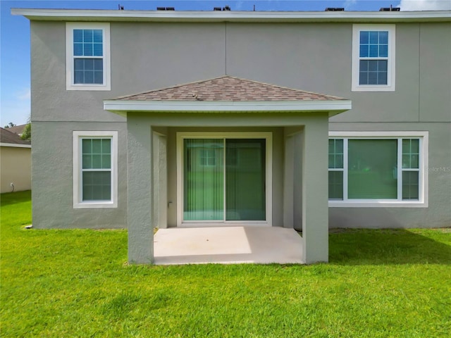 rear view of property with a patio and a yard