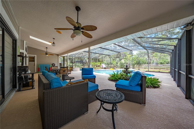 view of patio / terrace featuring outdoor lounge area, glass enclosure, and ceiling fan