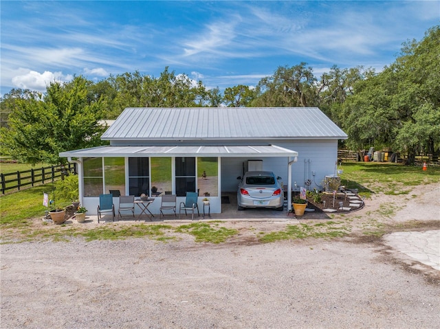 exterior space with a carport, driveway, and fence