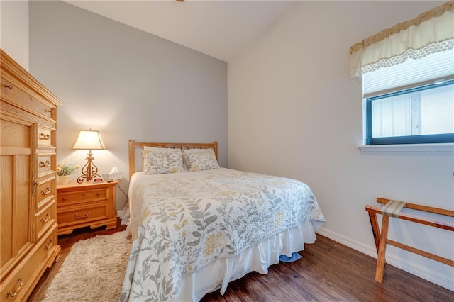 bedroom featuring lofted ceiling and dark wood-type flooring