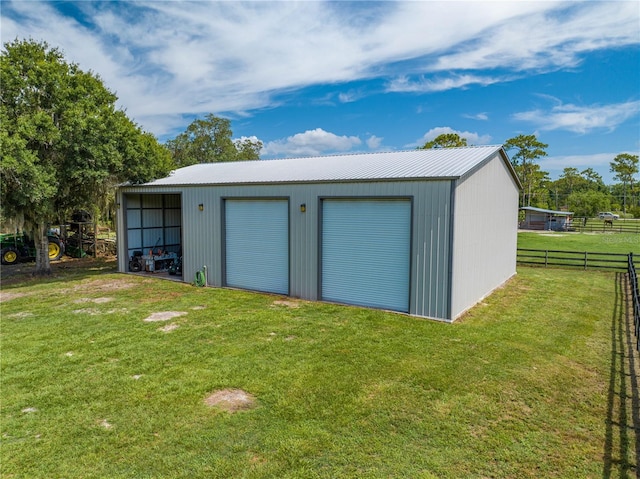 view of outbuilding featuring a garage and a yard