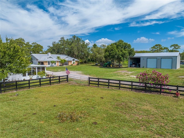 view of yard with a rural view and an outdoor structure