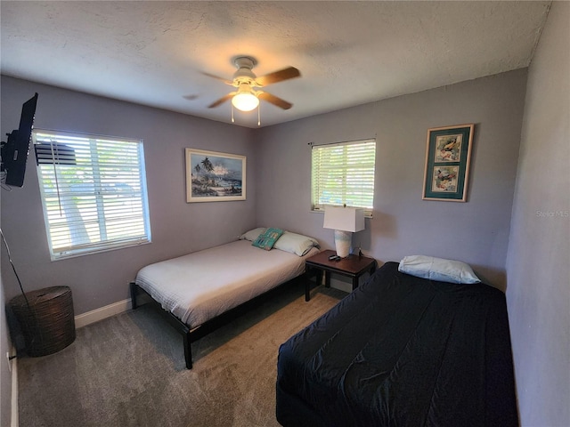 bedroom with ceiling fan, multiple windows, and carpet floors