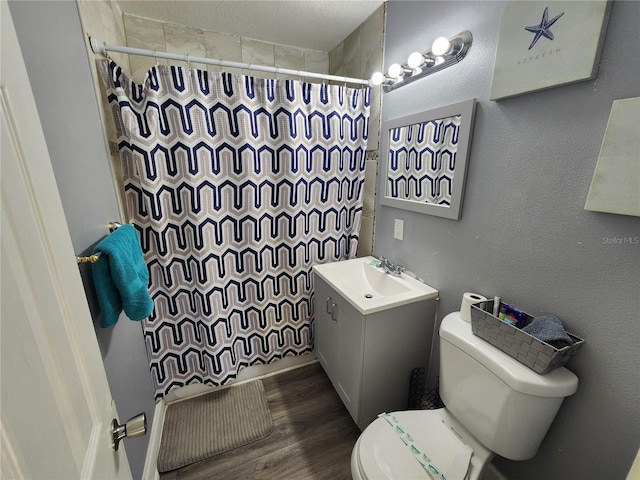 bathroom with wood-type flooring, toilet, and vanity