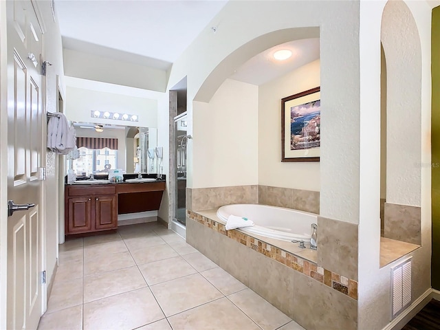 bathroom featuring tile patterned flooring, independent shower and bath, vanity, and ceiling fan