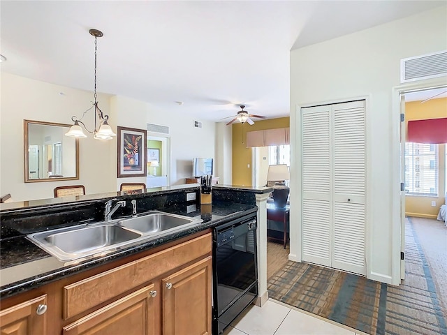 kitchen featuring dark stone counters, sink, light tile patterned floors, ceiling fan with notable chandelier, and dishwasher