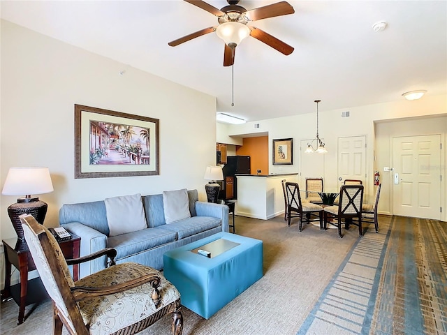 carpeted living room with ceiling fan