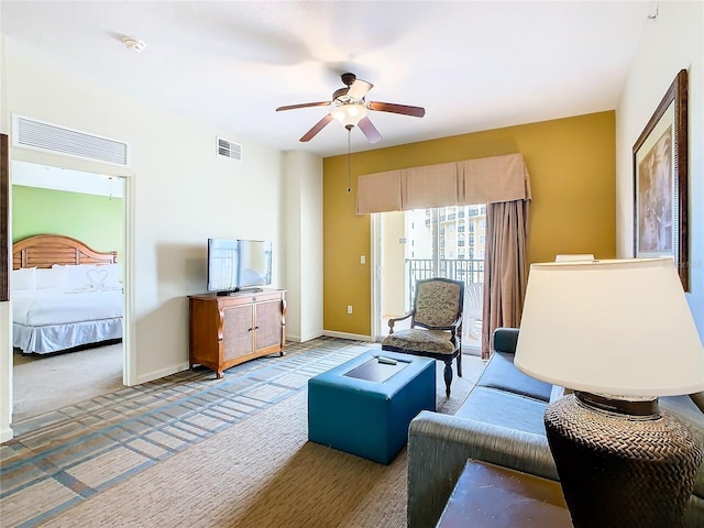 carpeted living room featuring ceiling fan