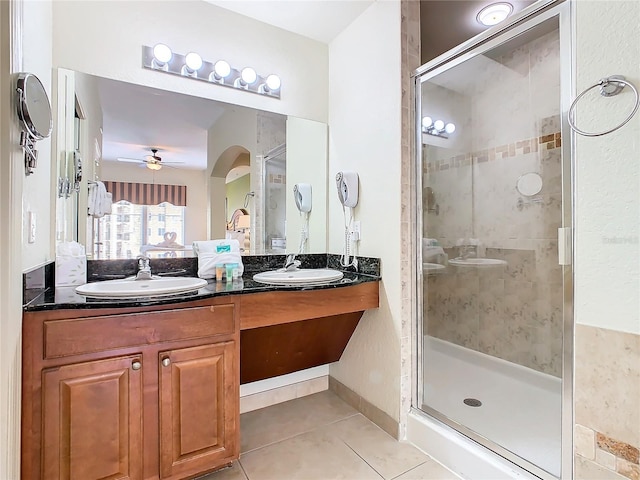 bathroom featuring tile patterned floors, double sink vanity, walk in shower, and ceiling fan