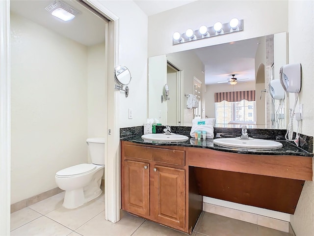 bathroom with double vanity, tile patterned floors, toilet, and ceiling fan