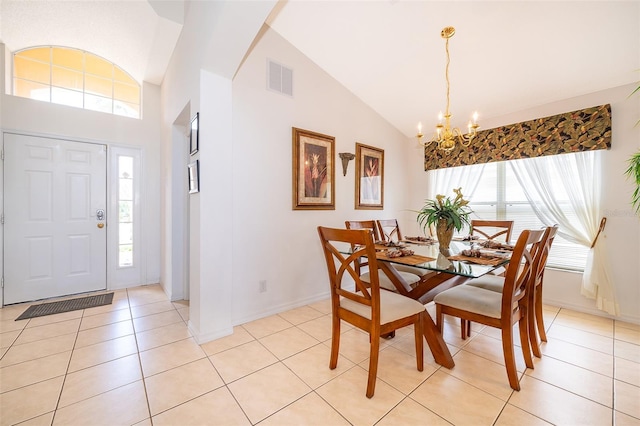 tiled dining room with high vaulted ceiling and a notable chandelier