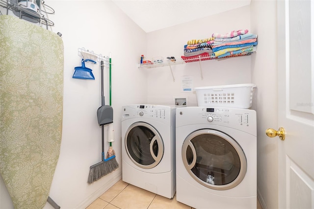 laundry area featuring light tile patterned floors and independent washer and dryer