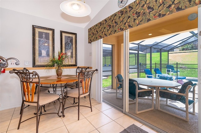 dining area featuring light tile patterned floors and lofted ceiling