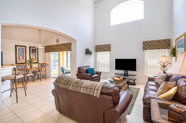 tiled living room with a high ceiling