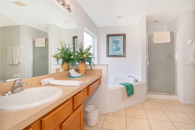 bathroom featuring vanity, tile patterned flooring, and plus walk in shower