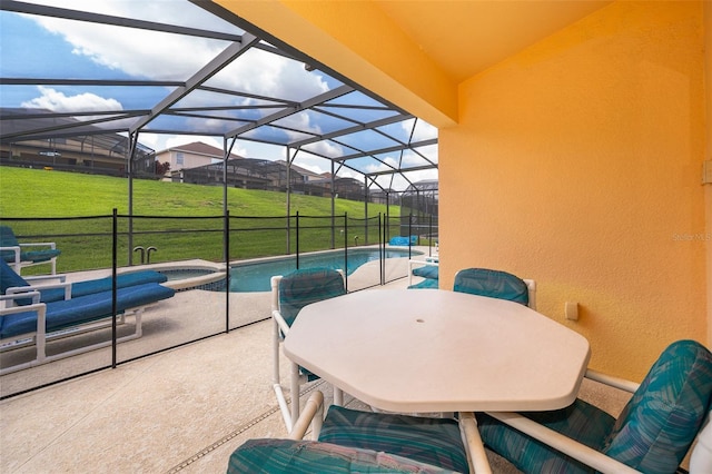 view of patio featuring glass enclosure and a swimming pool with hot tub