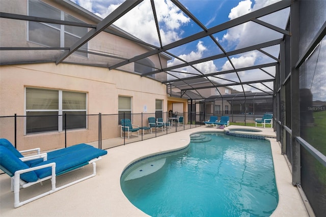 view of swimming pool with a lanai, a patio area, and an in ground hot tub