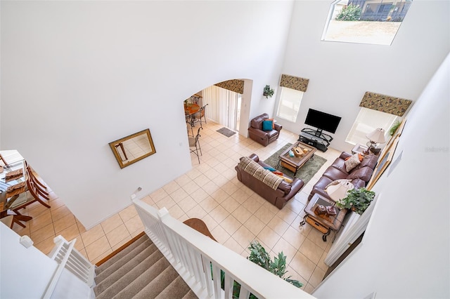 tiled living room with a towering ceiling