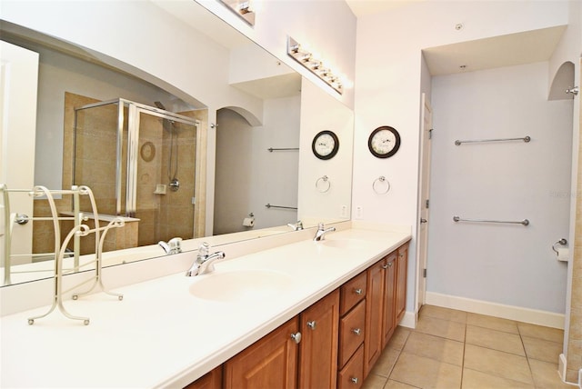 bathroom featuring vanity, tile patterned floors, and walk in shower