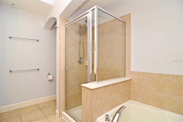 bathroom featuring tile patterned flooring and shower with separate bathtub