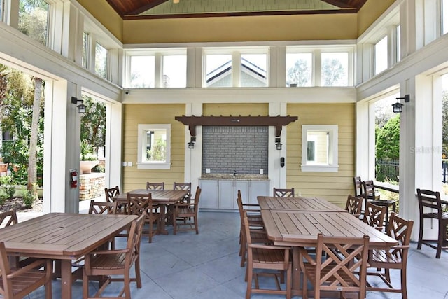 sunroom / solarium with a healthy amount of sunlight and vaulted ceiling