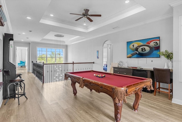 playroom with crown molding, a tray ceiling, and light hardwood / wood-style flooring