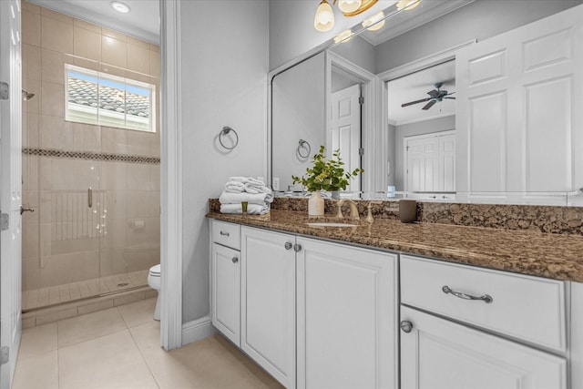 bathroom with tile patterned flooring, ornamental molding, vanity, an enclosed shower, and toilet