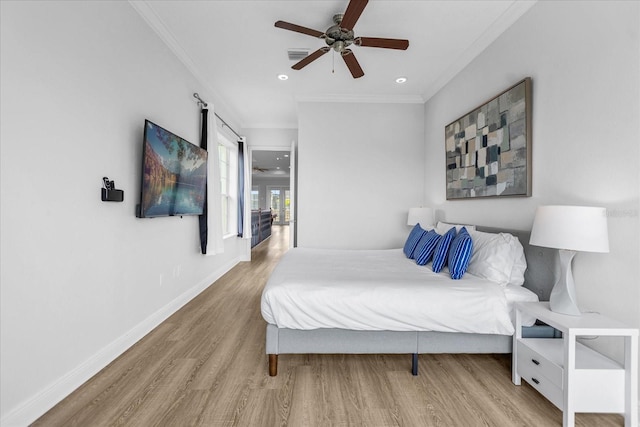 bedroom with crown molding, ceiling fan, and hardwood / wood-style flooring