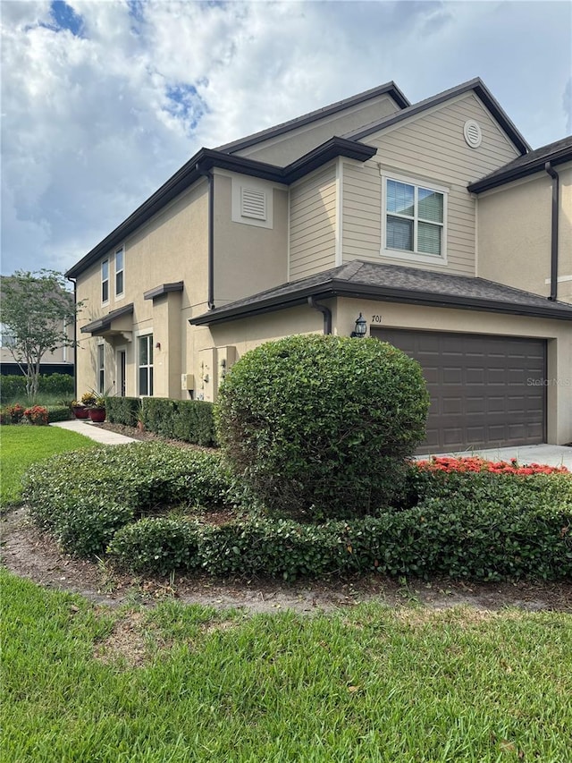 view of side of home with a garage and a yard