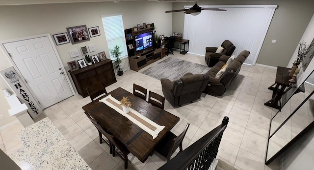 tiled living room featuring ceiling fan and vaulted ceiling