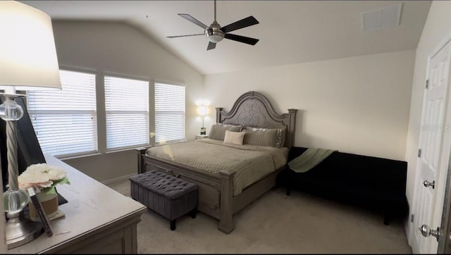 carpeted bedroom with multiple windows, vaulted ceiling, and ceiling fan