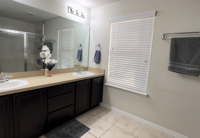 bathroom featuring vanity, a shower with shower door, and tile patterned floors